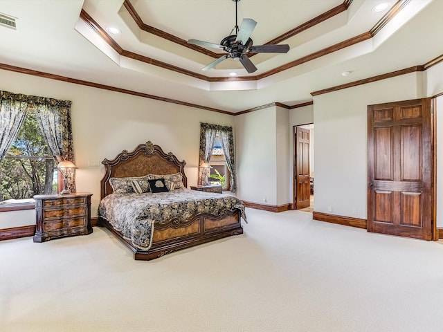 bedroom with ceiling fan, ornamental molding, a raised ceiling, and carpet