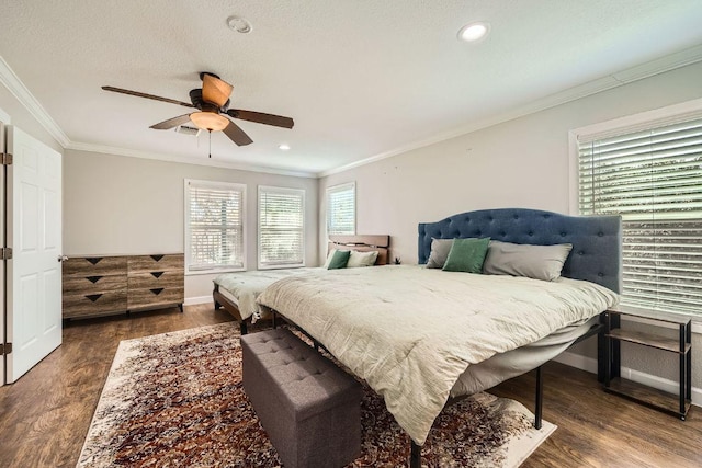 bedroom with wood finished floors, baseboards, and ornamental molding