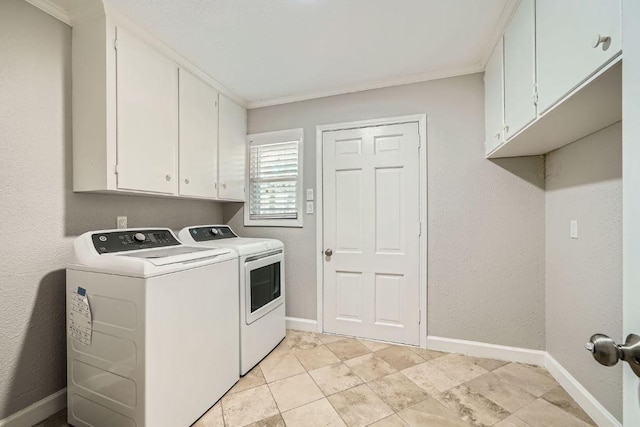 laundry room with cabinet space, crown molding, baseboards, washing machine and clothes dryer, and a textured wall