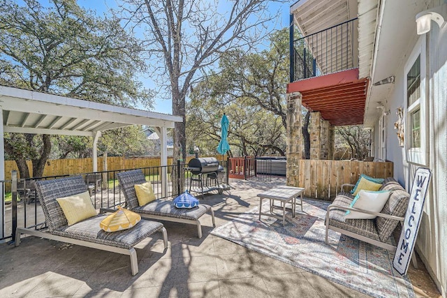 view of patio featuring area for grilling, an outdoor living space, fence, a balcony, and a hot tub