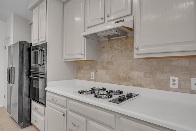 kitchen featuring white cabinets, light tile patterned floors, backsplash, and black appliances