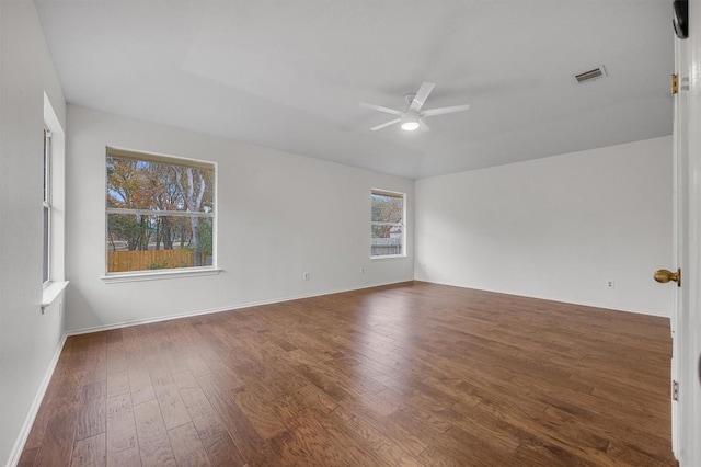 empty room with ceiling fan and dark hardwood / wood-style floors