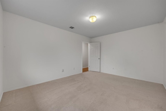 empty room featuring light carpet