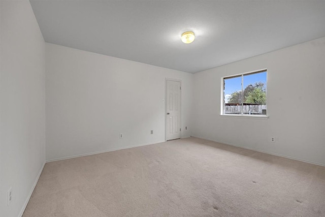 unfurnished room with light colored carpet