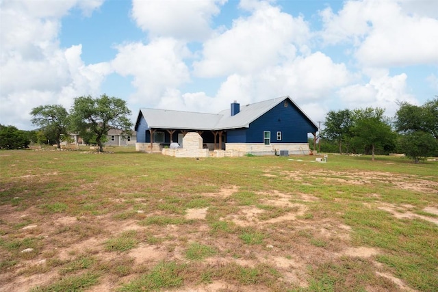 exterior space featuring a lawn and central AC unit