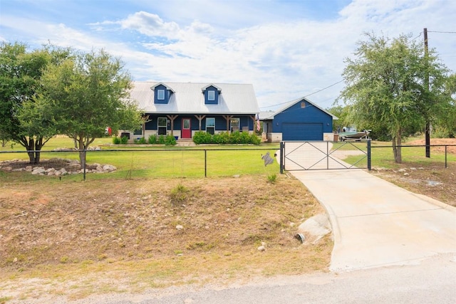 view of front facade featuring a garage, metal roof, a front yard, and fence