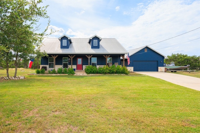 cape cod-style house with a porch, a garage, a front lawn, and an outdoor structure