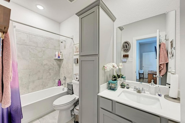 full bathroom with toilet, tile patterned flooring, vanity, and shower / bathing tub combination