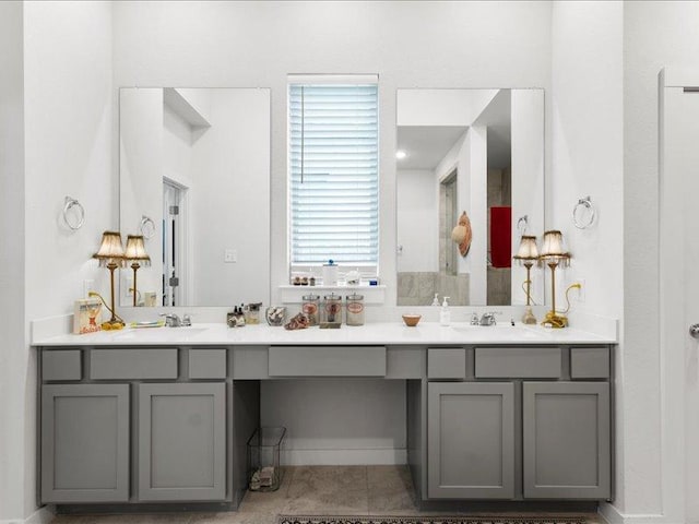 bathroom with double vanity, a sink, and tile patterned floors