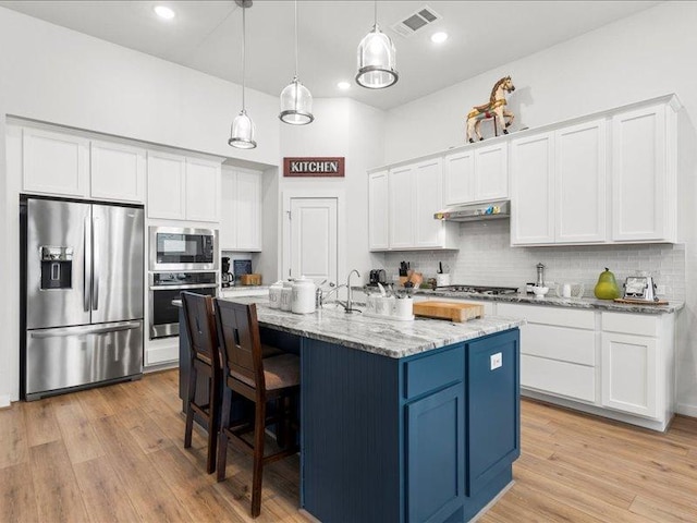 kitchen with visible vents, appliances with stainless steel finishes, white cabinets, light wood-type flooring, and under cabinet range hood