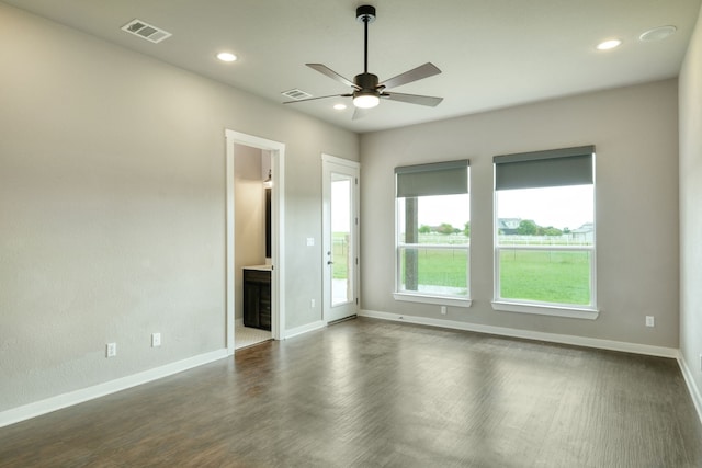 empty room with dark hardwood / wood-style floors and ceiling fan