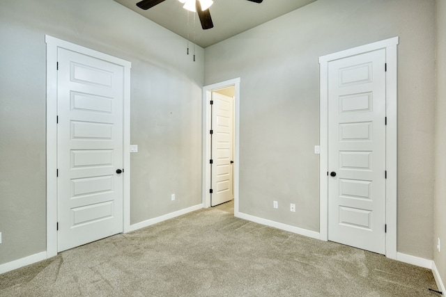 unfurnished bedroom with ceiling fan and light carpet