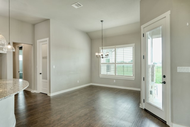 unfurnished dining area with dark hardwood / wood-style flooring, a chandelier, and vaulted ceiling