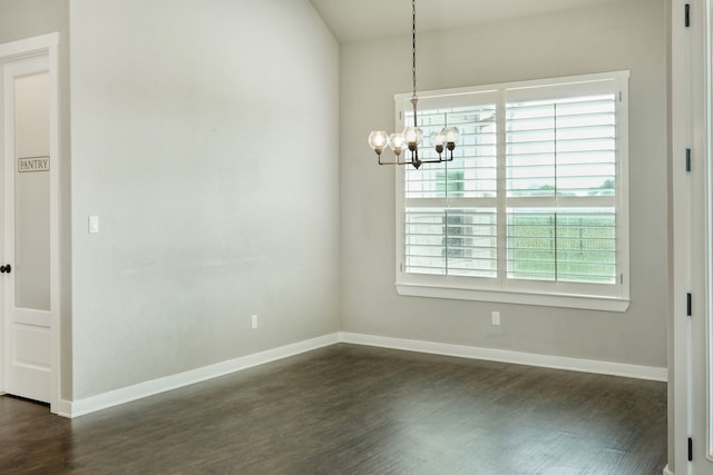 unfurnished dining area with dark hardwood / wood-style floors and a chandelier