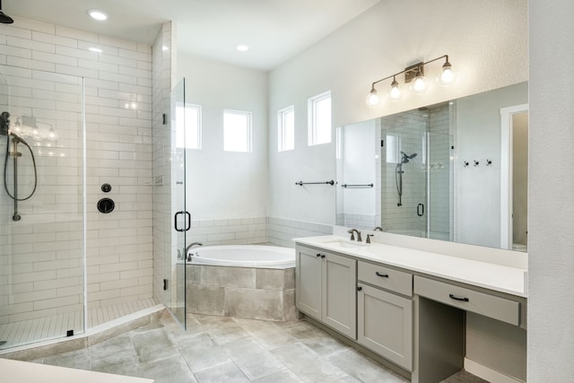 bathroom with tile patterned flooring, vanity, and independent shower and bath