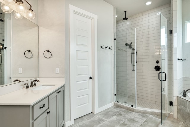 bathroom with vanity and separate shower and tub