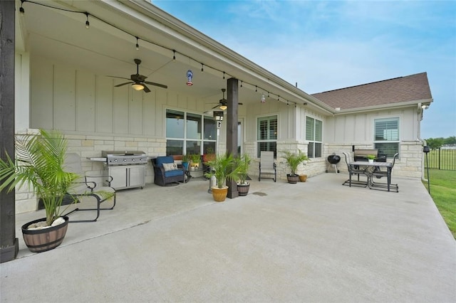 view of patio with area for grilling and ceiling fan