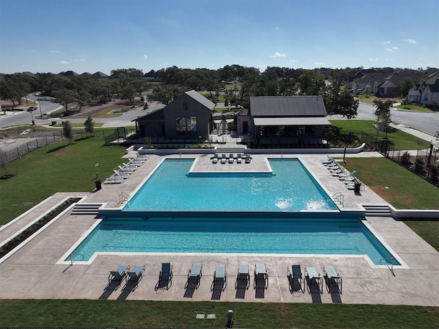 view of swimming pool featuring a yard and a patio