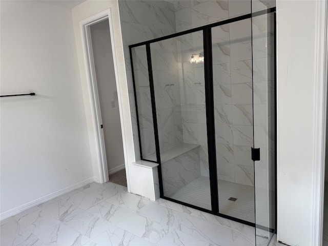 bathroom with a shower with door