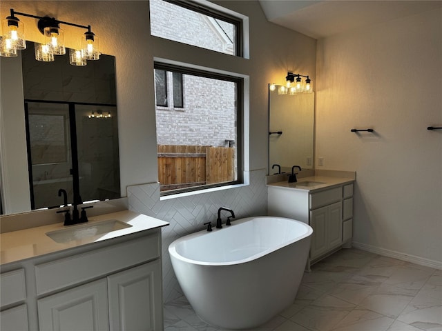 bathroom featuring backsplash, vanity, and shower with separate bathtub