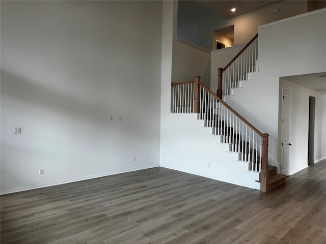 interior space featuring a high ceiling and dark hardwood / wood-style flooring