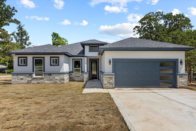 prairie-style house with a front yard and a garage