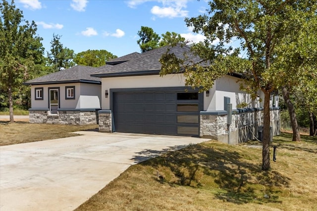 view of front of property with a garage and a front lawn