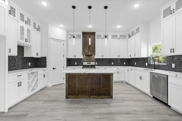 kitchen with a center island, stainless steel appliances, tasteful backsplash, and hanging light fixtures