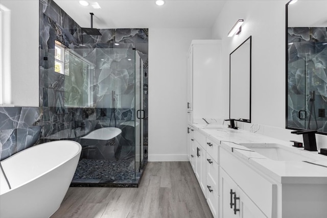 bathroom with hardwood / wood-style floors, separate shower and tub, decorative backsplash, and vanity