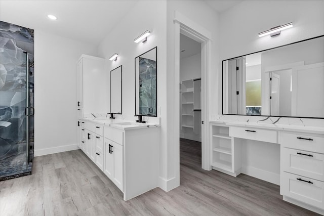 bathroom featuring vanity, a shower with shower door, and hardwood / wood-style floors