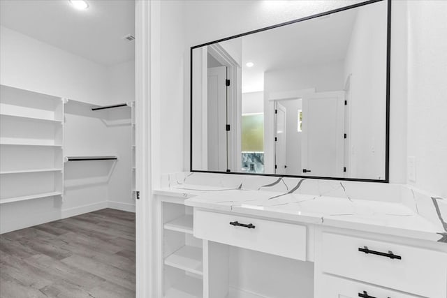 bathroom with vanity and wood-type flooring