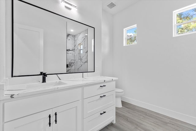 bathroom with vanity, toilet, walk in shower, and hardwood / wood-style floors