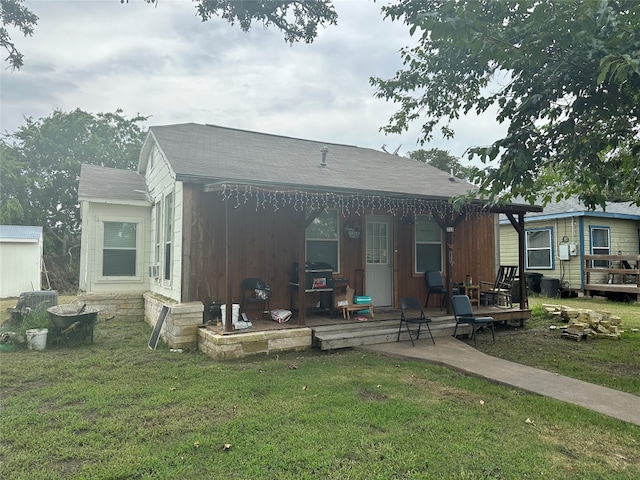 view of front facade with a deck and a front lawn