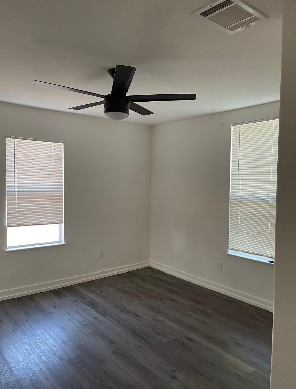 spare room with ceiling fan and hardwood / wood-style flooring