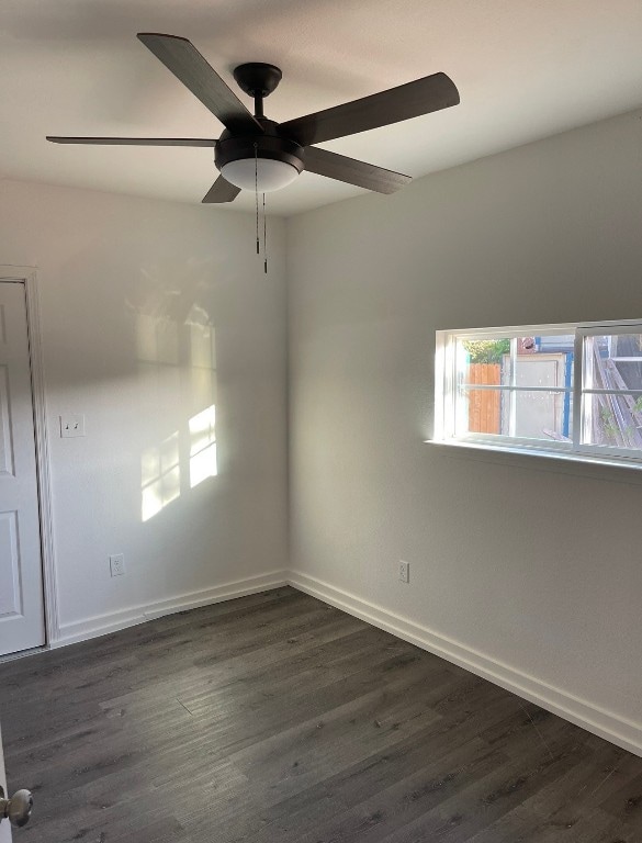 empty room with dark hardwood / wood-style floors and ceiling fan