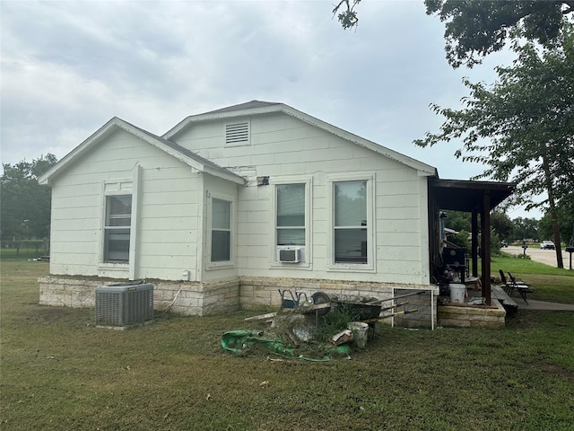 back of property with a lawn and cooling unit