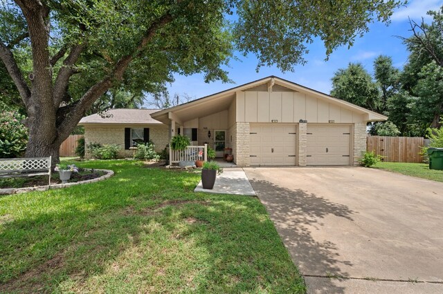 ranch-style home with a garage and a front yard