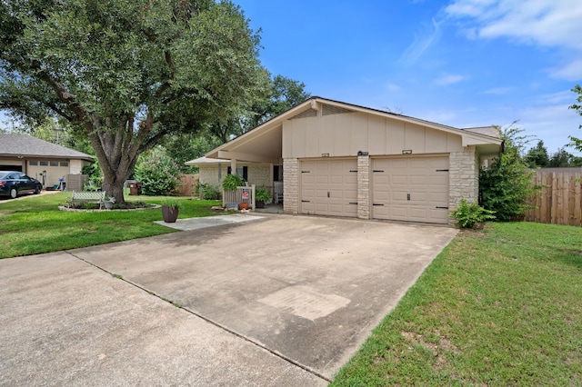 ranch-style home with a garage and a front lawn