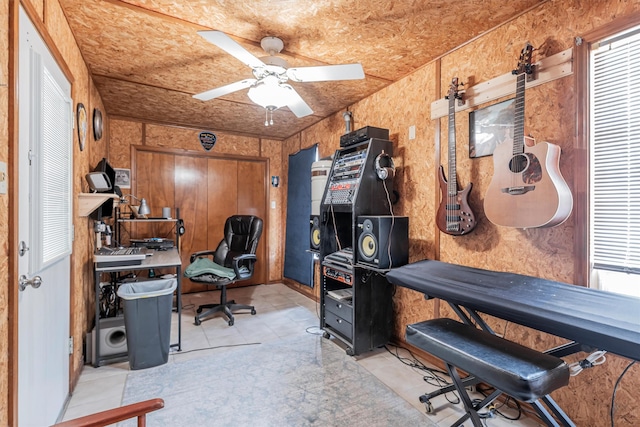 office with ceiling fan and wooden walls