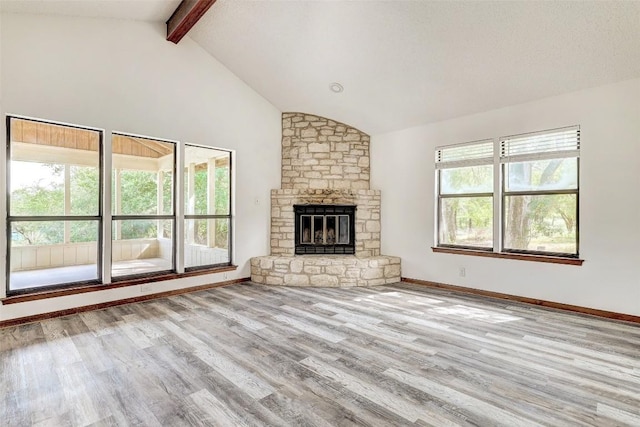 unfurnished living room featuring a fireplace, vaulted ceiling with beams, baseboards, and wood finished floors