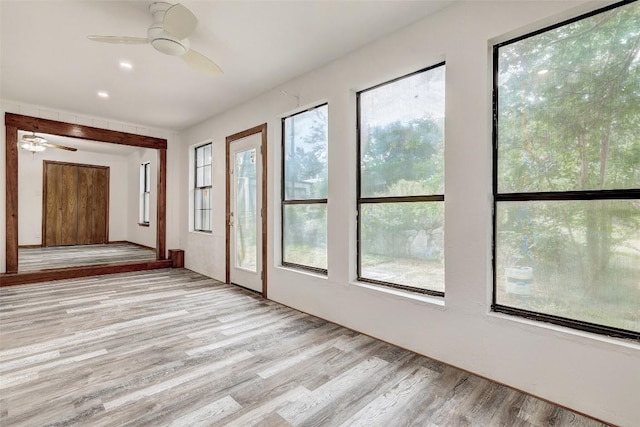 interior space with plenty of natural light, light wood-type flooring, and a ceiling fan