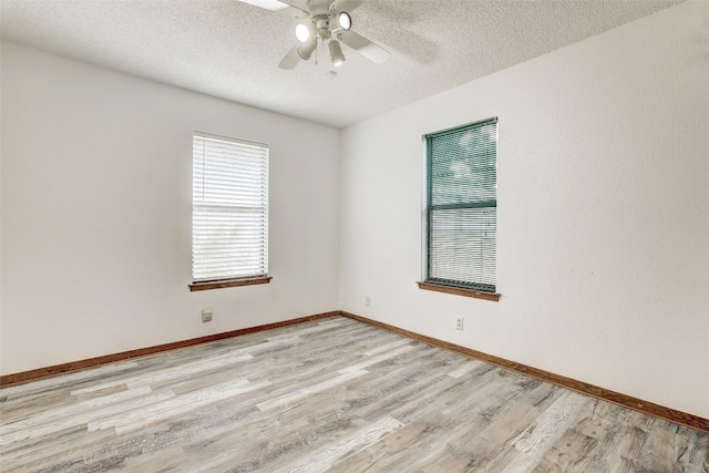 unfurnished room featuring a textured ceiling, hardwood / wood-style flooring, and ceiling fan