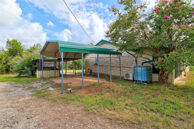 view of yard featuring a detached carport and ac unit