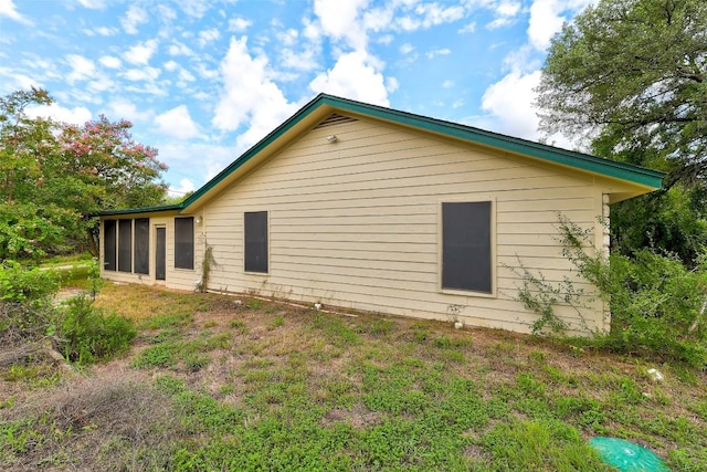 view of side of home featuring a sunroom