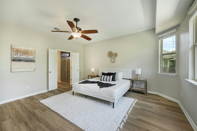 bedroom with ceiling fan and dark wood-type flooring