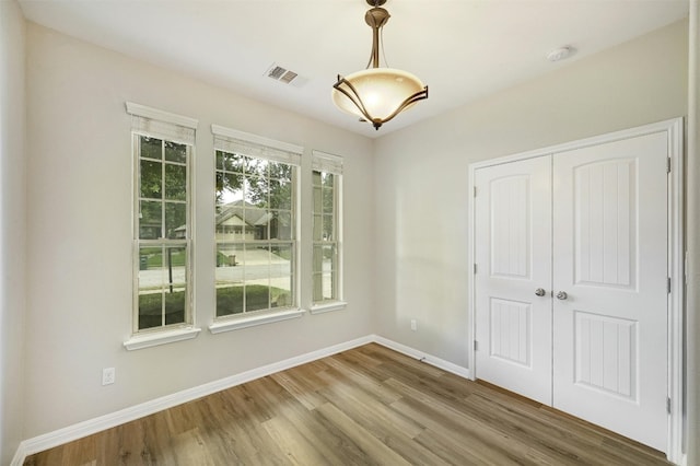 empty room with hardwood / wood-style flooring