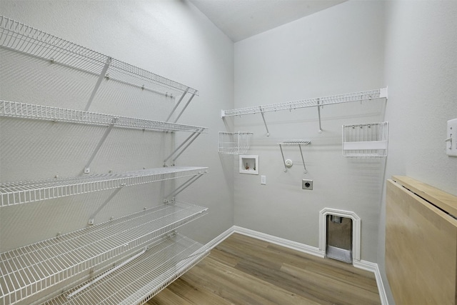 clothes washing area with washer hookup, hardwood / wood-style flooring, hookup for a gas dryer, and electric dryer hookup