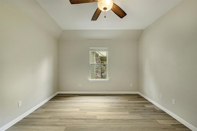 empty room featuring light hardwood / wood-style floors, lofted ceiling, and ceiling fan