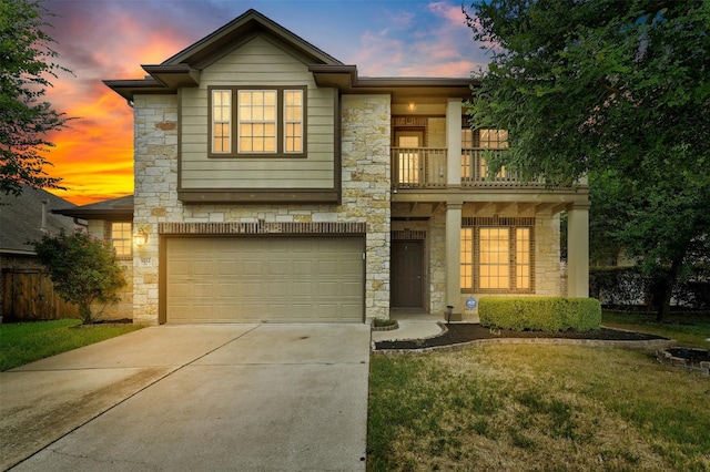 view of front of property featuring a balcony, a garage, and a yard