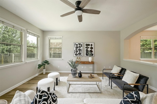 living area with light hardwood / wood-style flooring and ceiling fan